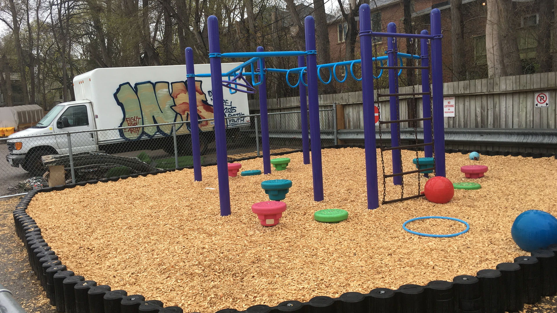 A daycare playground with Fibertop playground bordering